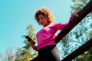 Woman checking her financial fitness on her phone 